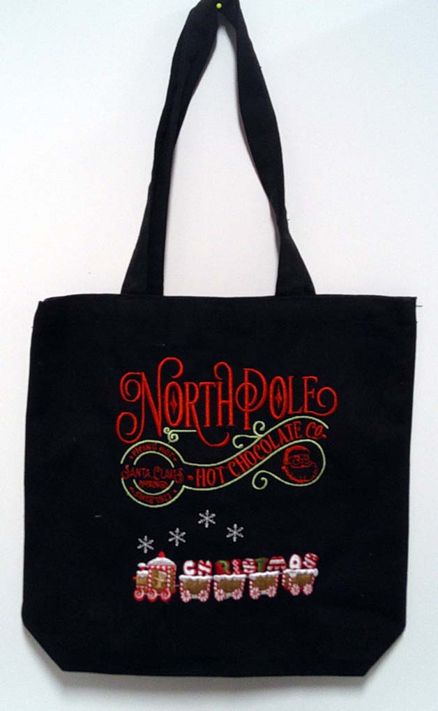 Black canvas tote with Christmas saying