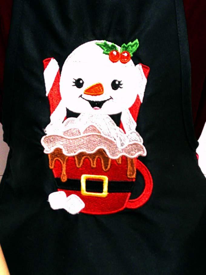 Black child's apron with snowman embroidery design